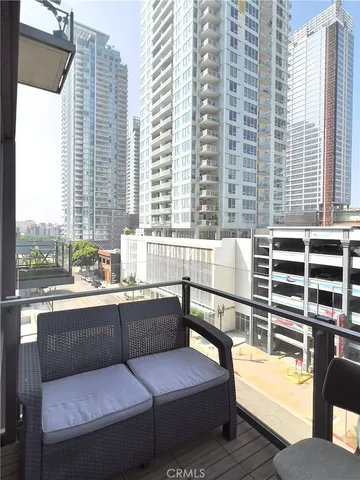 a view of a balcony with couch and wooden floor