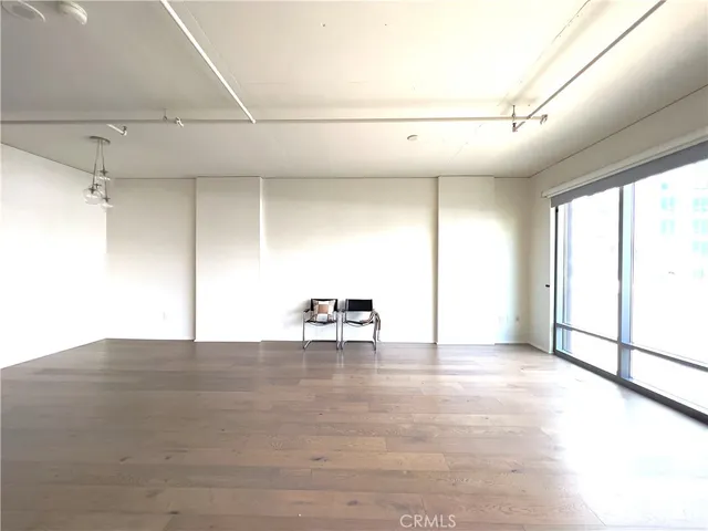 a view of a livingroom with a ceiling fan and window