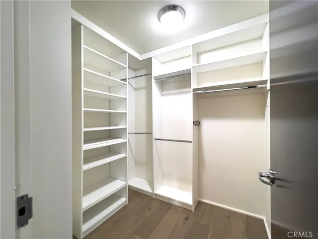 a view of walk in closet with empty racks
