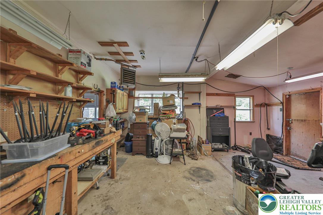 331 Cranberry Creek Road Cresco, PA 18326 - Photo 40 of 95 A well-equipped workshop with ample shelving and a concrete floor, perfect for any project.