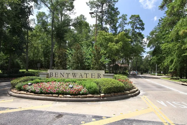 a view of a white house with a yard and potted plants