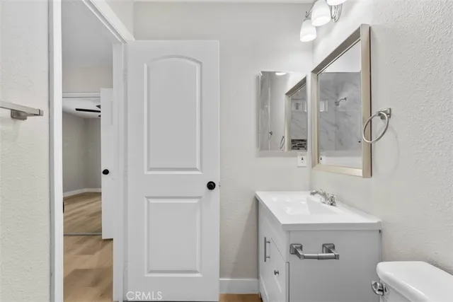 a bathroom with a sink mirror and toilet