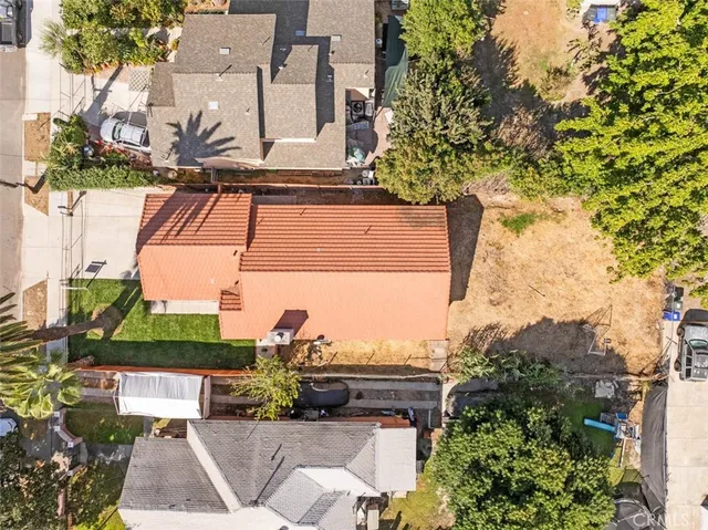 an aerial view of a house with a yard and sitting area