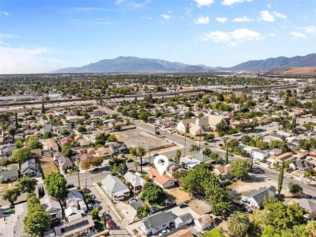 an aerial view of residential houses with outdoor space and trees