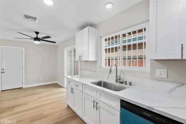 a kitchen with a sink appliances and cabinets