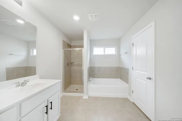 a bathroom with a bathtub and a sink