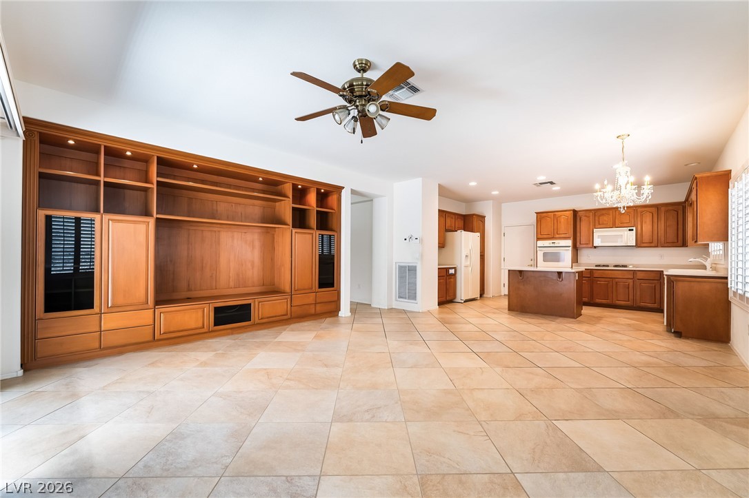 3033 Hartsville Road Henderson, NV 89052 - Photo 14 of 41 An open-concept living space features built-in shelving and a well-appointed kitchen.