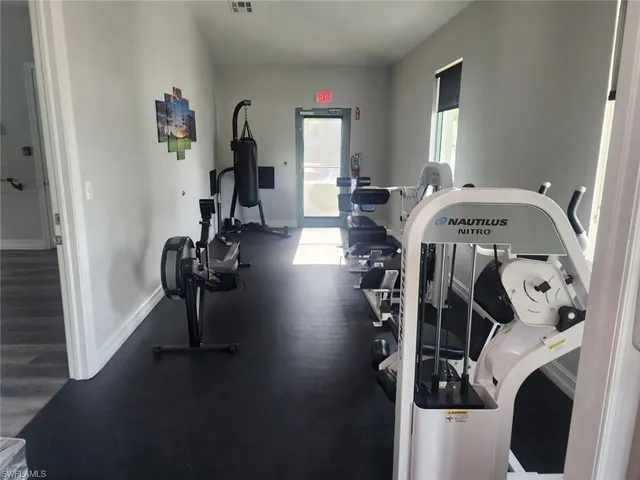 a view of a livingroom with furniture hardwood floor and a window
