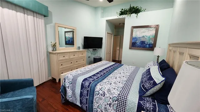 a bedroom with a bed and a television