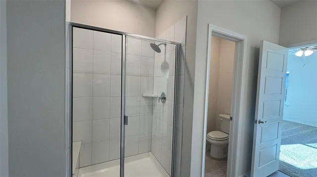 a bathroom that has a glass shower door