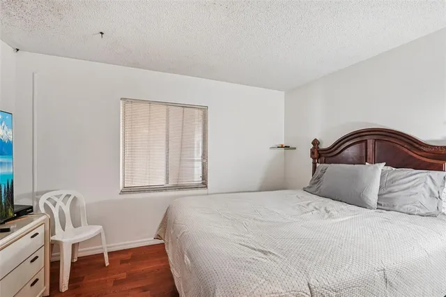 a bedroom with a bed and a mirror