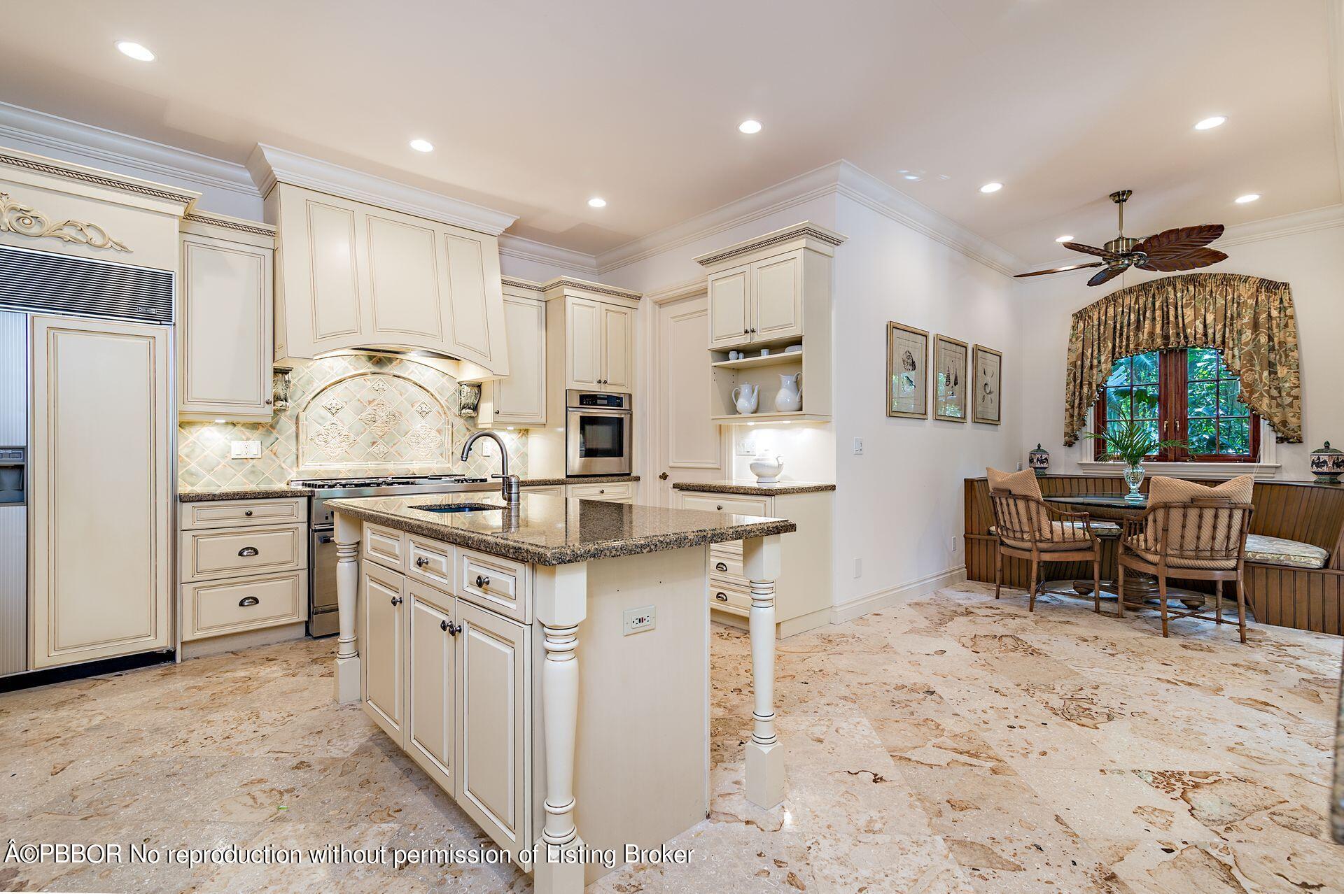 250 Country Club Road Palm Beach, FL 33480 - Photo 17 of 33 a kitchen with granite countertop a sink and cabinets