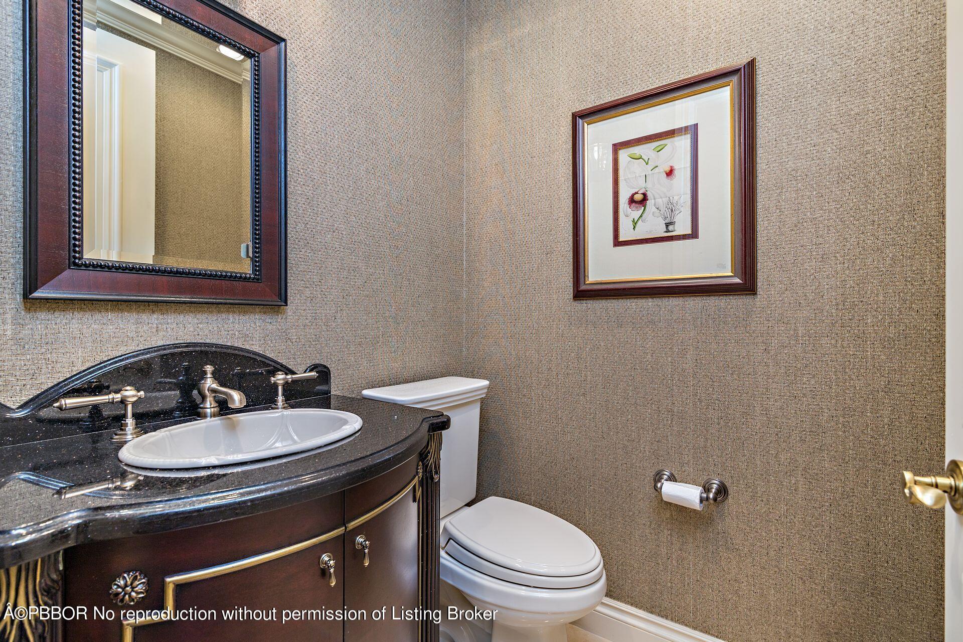 250 Country Club Road Palm Beach, FL 33480 - Photo 25 of 33 a bathroom with a sink a toilet and mirror