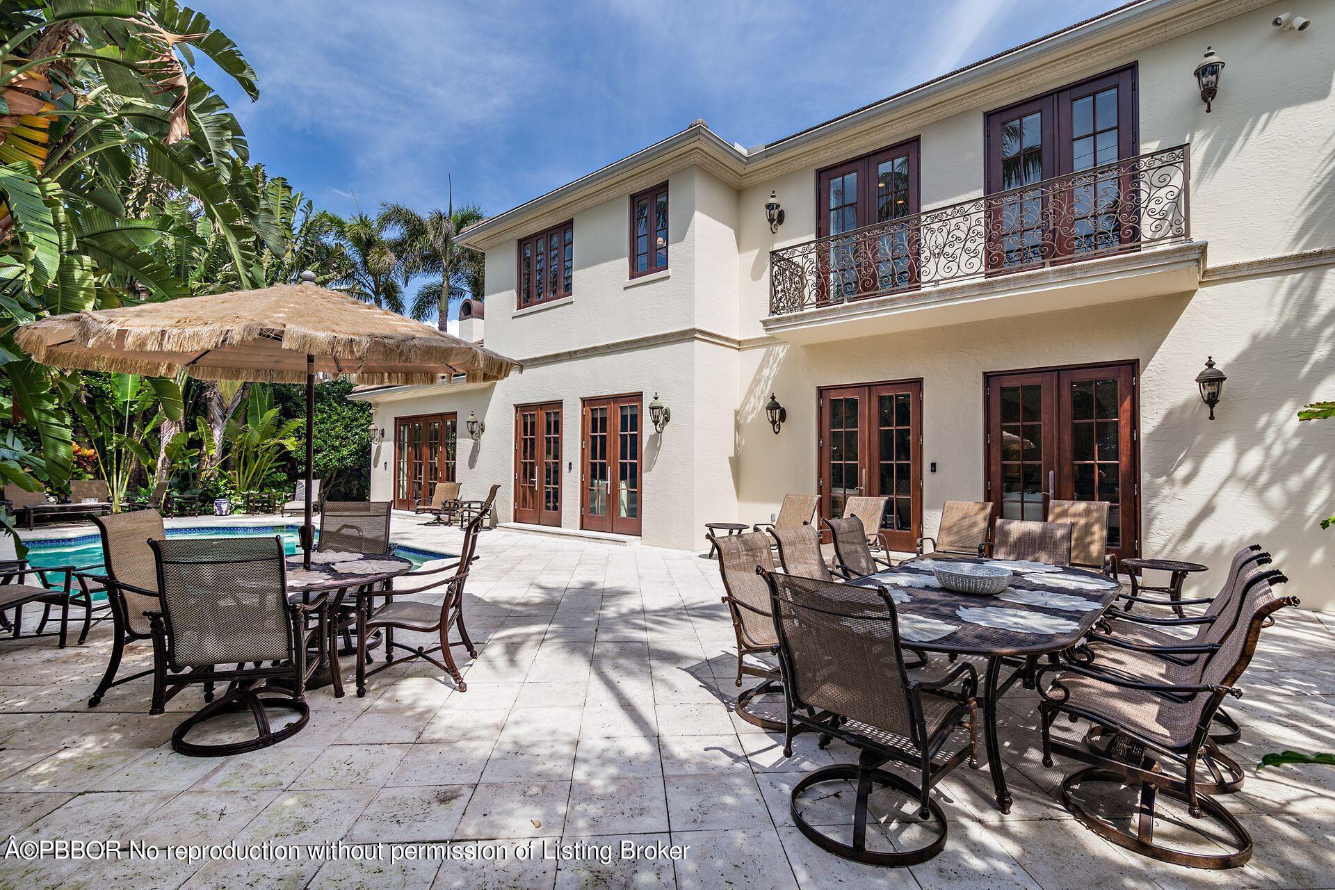 250 Country Club Road Palm Beach, FL 33480 - Photo 28 of 33 a view of a patio with table and chairs and floor to ceiling window