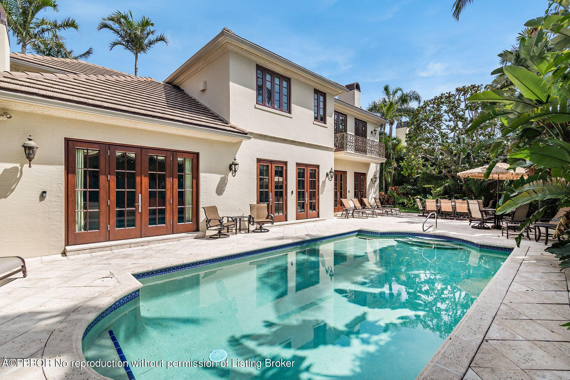 250 Country Club Road Palm Beach, FL 33480 - Photo 29 of 33 a swimming pool with outdoor seating