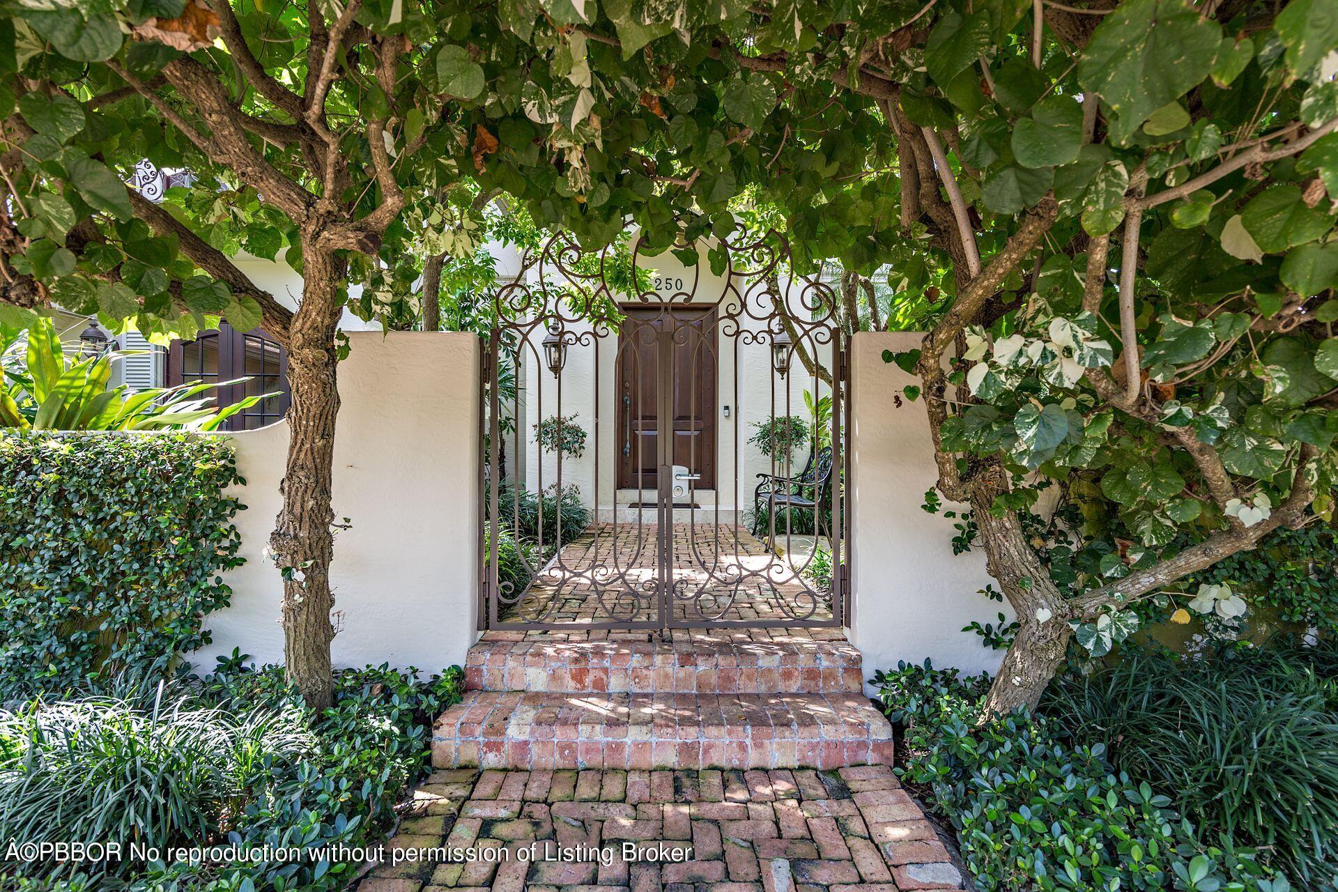 250 Country Club Road Palm Beach, FL 33480 - Photo 32 of 33 a view of a backyard with large trees