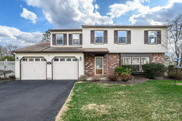 a front view of a house with a garden and plants