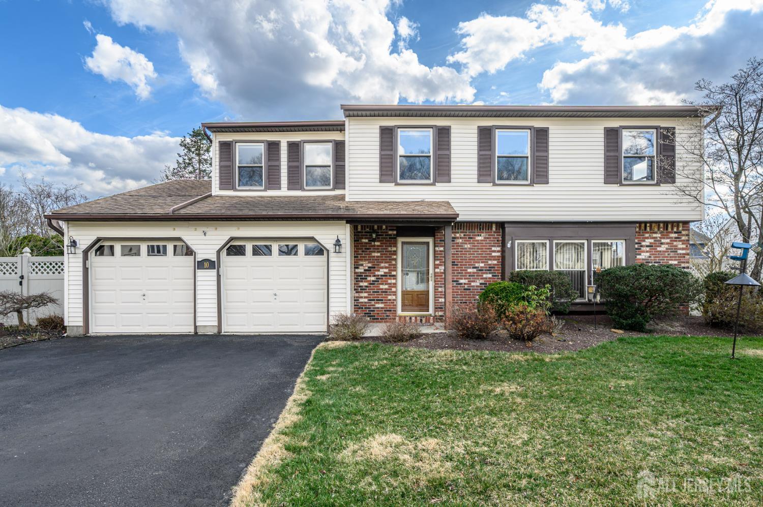 10 Eric Drive Howell, NJ 07731 - Photo 1 of 43 a front view of a house with a garden and plants
