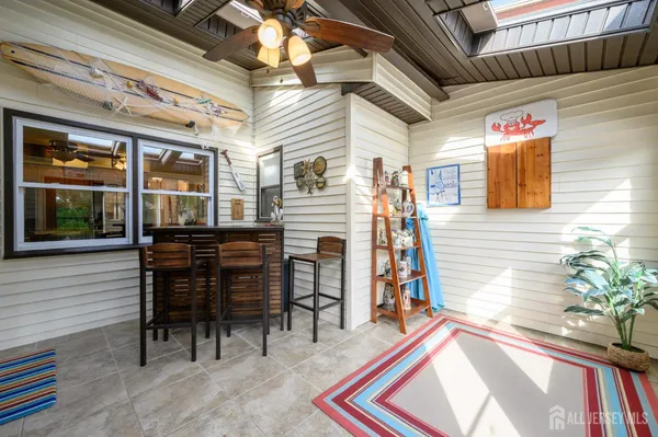 a backyard of a house with barbeque oven table and chairs