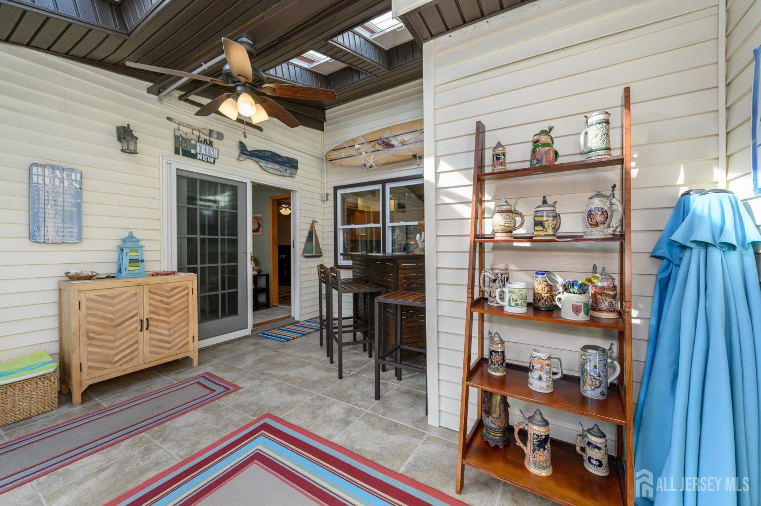 10 Eric Drive Howell, NJ 07731 - Photo 17 of 43 a living room with furniture and a book shelf