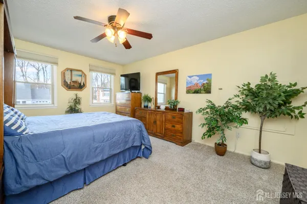 a bedroom with furniture and a chandelier