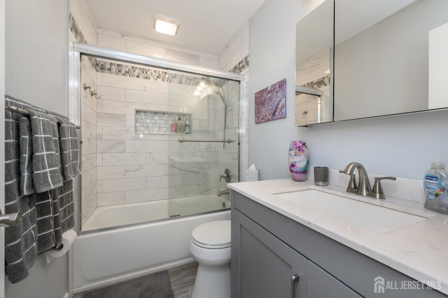 10 Eric Drive Howell, NJ 07731 - Photo 28 of 43 a bathroom with a sink a toilet and shower