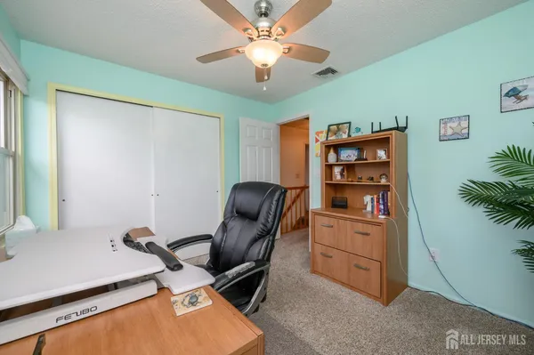 a view of workspace with furniture and cabinet