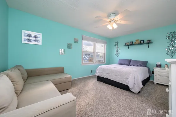 a bedroom with a bed couch and window