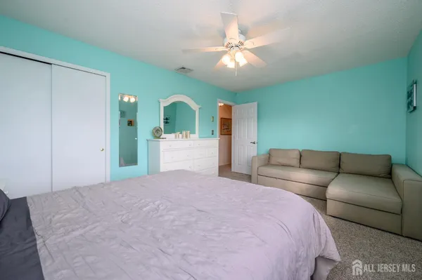 a bedroom with a large bed and a chandelier