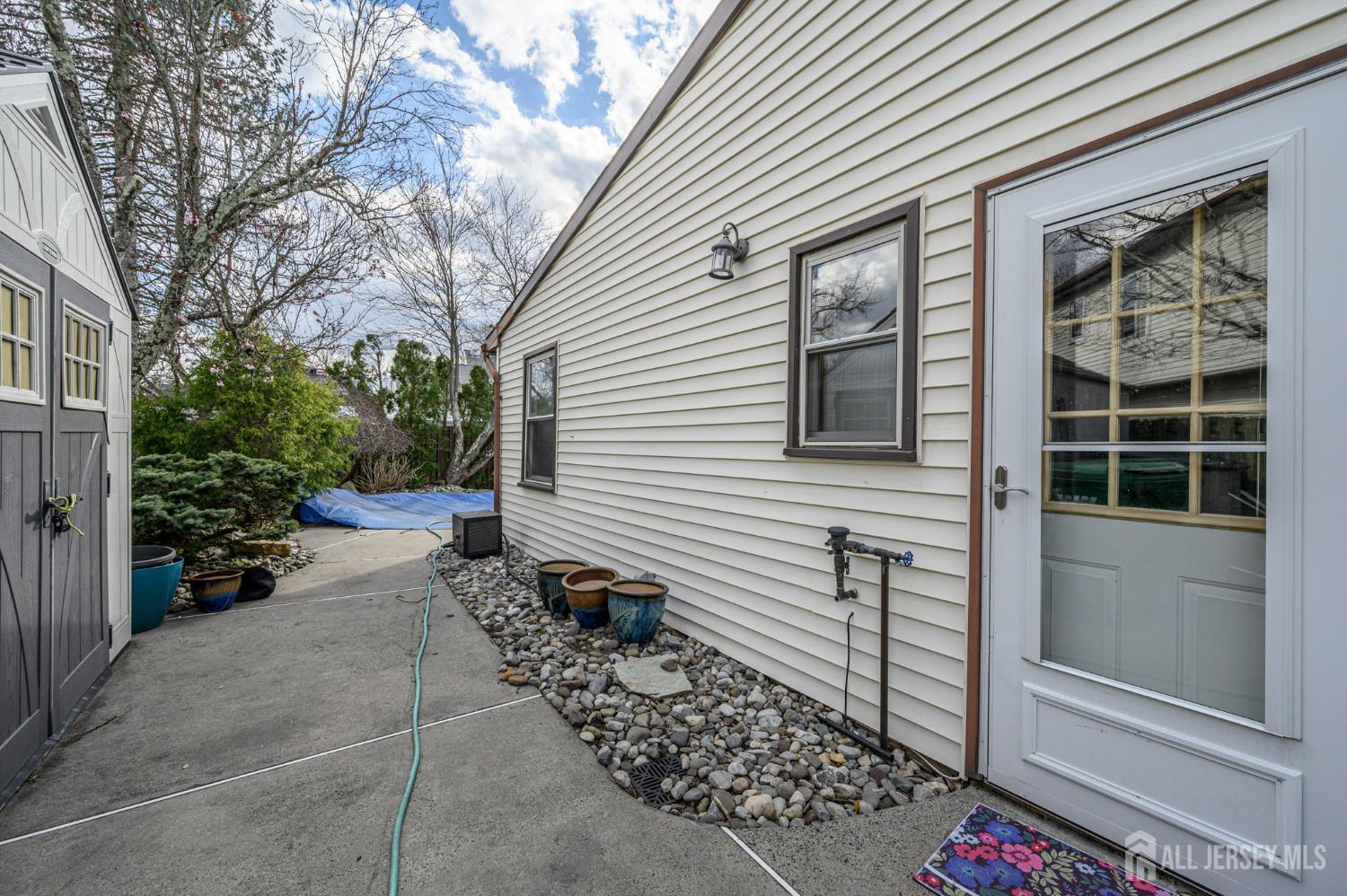 10 Eric Drive Howell, NJ 07731 - Photo 35 of 43 a view of a house with a bench and potted plants