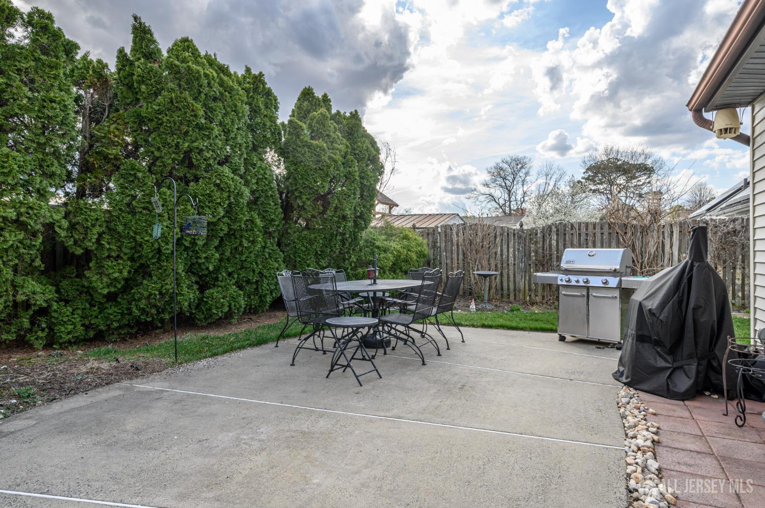 10 Eric Drive Howell, NJ 07731 - Photo 39 of 43 a view of backyard with table and chairs and a barbeque