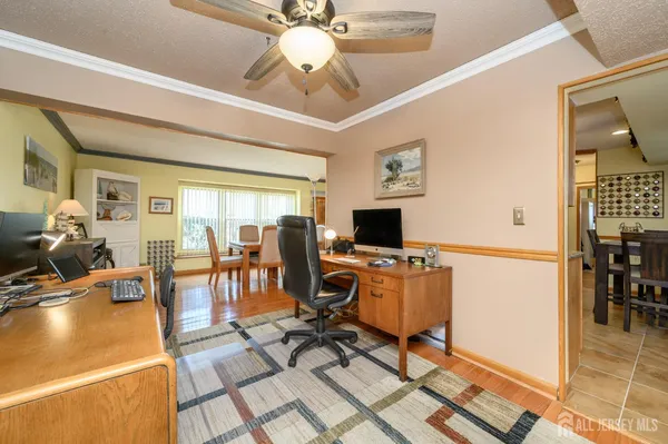 a view of a livingroom with workspace and a window