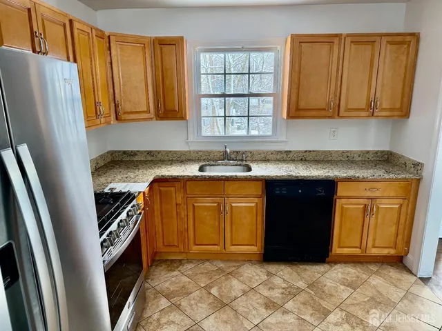 a view of a hallway with wooden floor and stairs