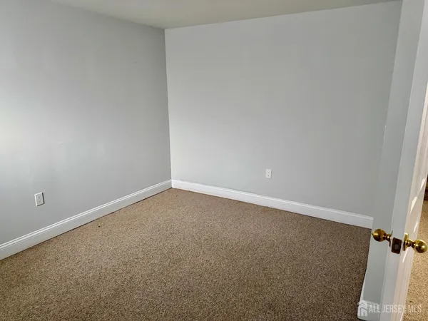 a view of a hallway with wooden floor and entryway