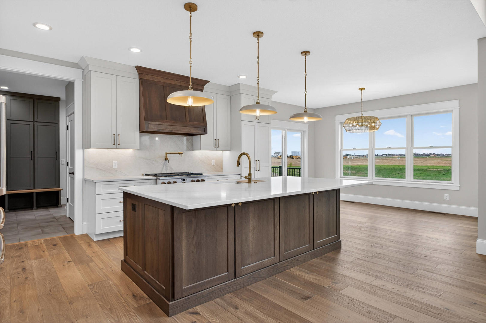 6928 Wilderness Pointe Bettendorf, IA 52722 - Photo 16 of 48 a kitchen with a sink a stove and a wooden floor