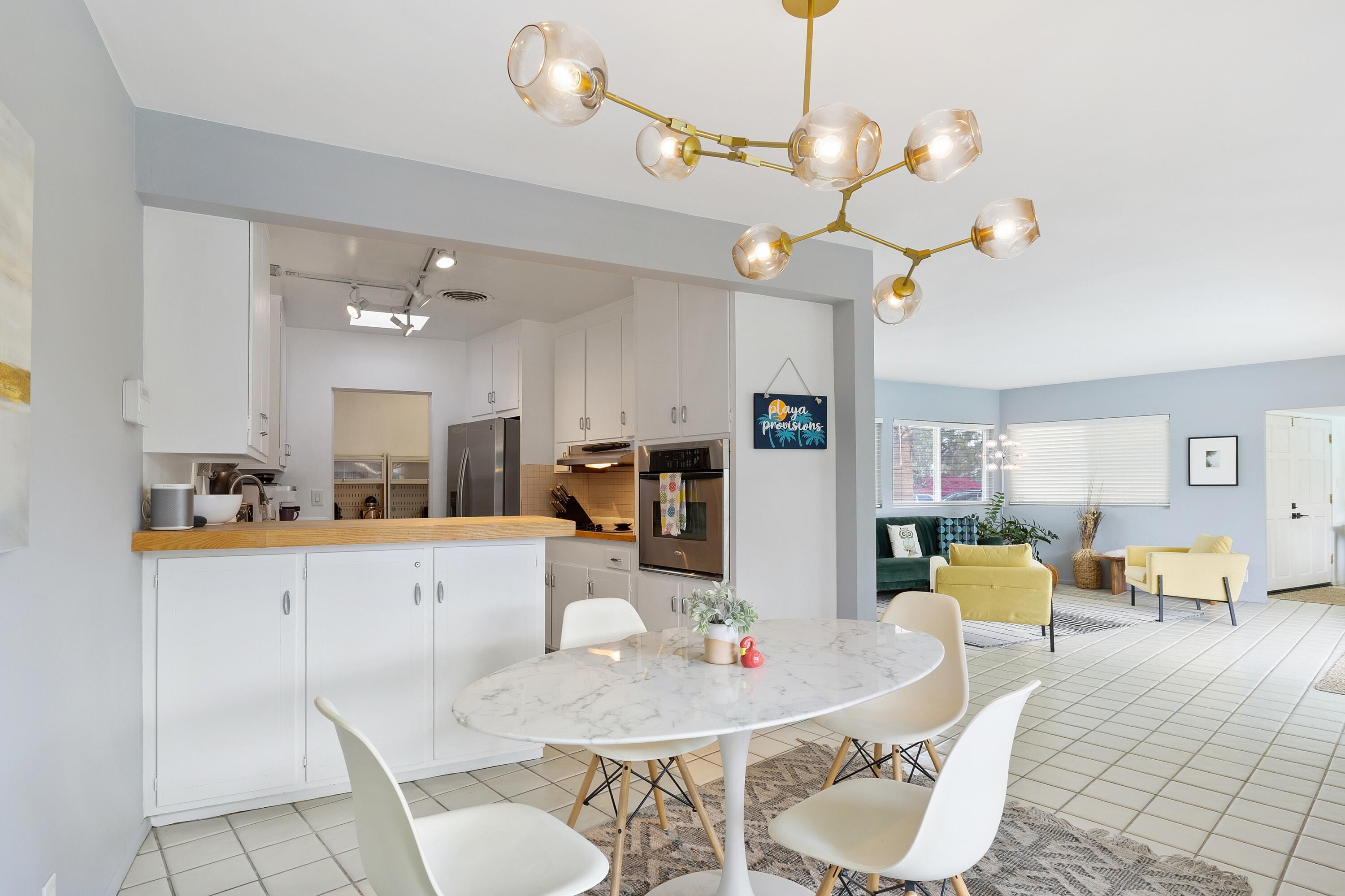 74533 Peppertree Drive Palm Desert, CA 92260 - Photo 11 of 34 a living room with furniture kitchen view and a chandelier