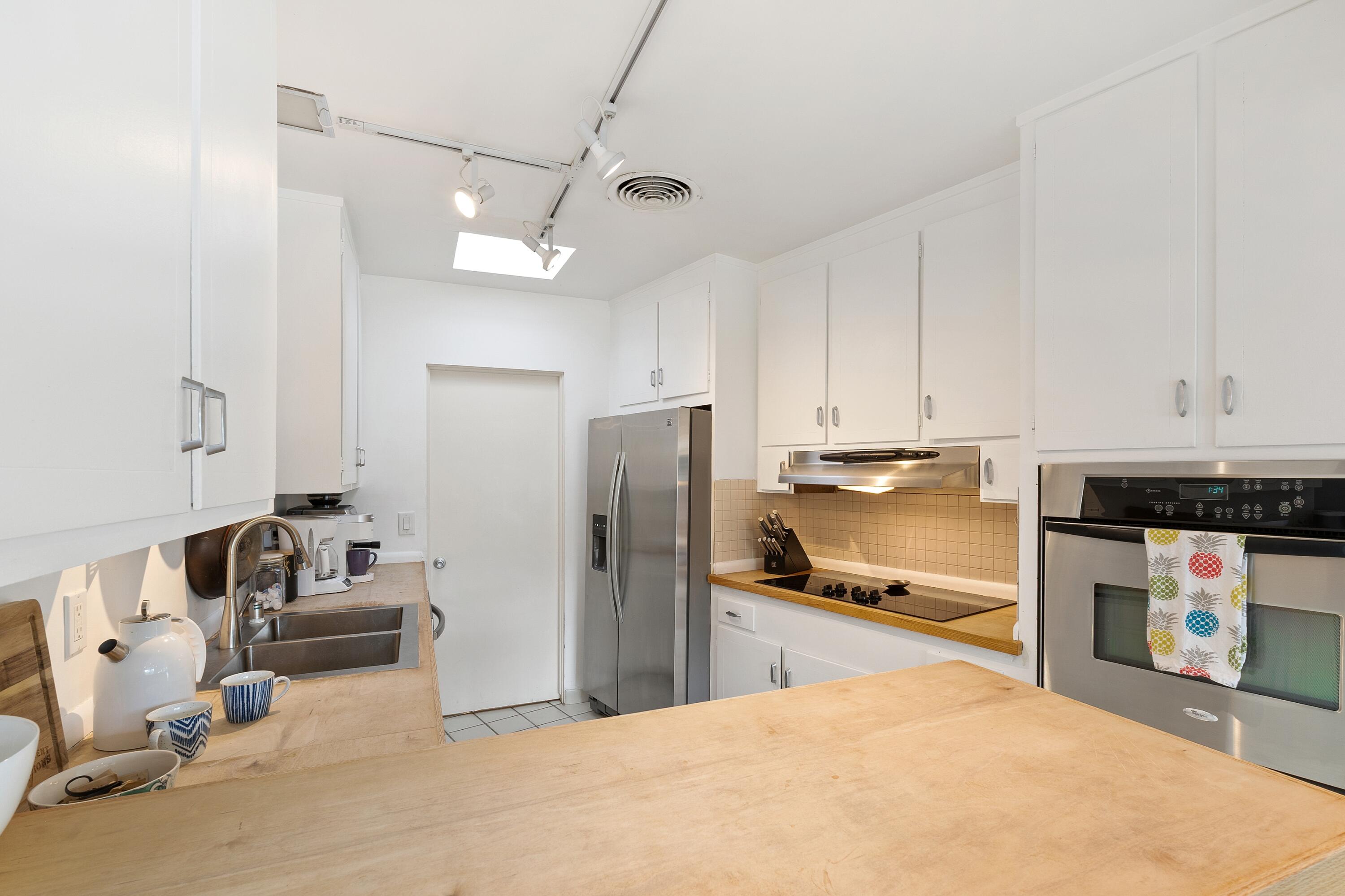74533 Peppertree Drive Palm Desert, CA 92260 - Photo 12 of 34 a kitchen with stainless steel appliances granite countertop a refrigerator and a sink