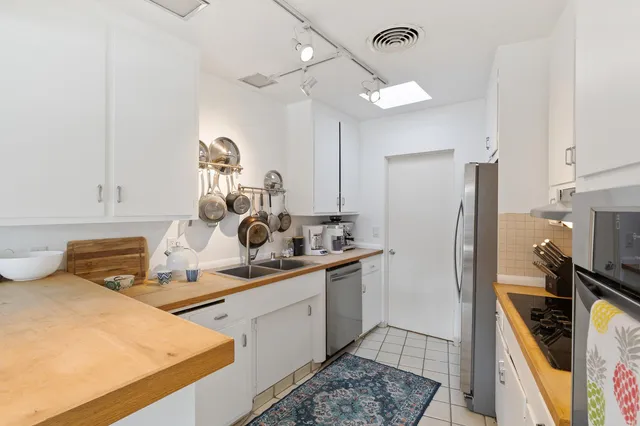 a kitchen with sink refrigerator and stove