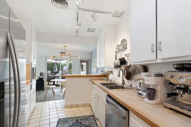 a kitchen with sink and refrigerator