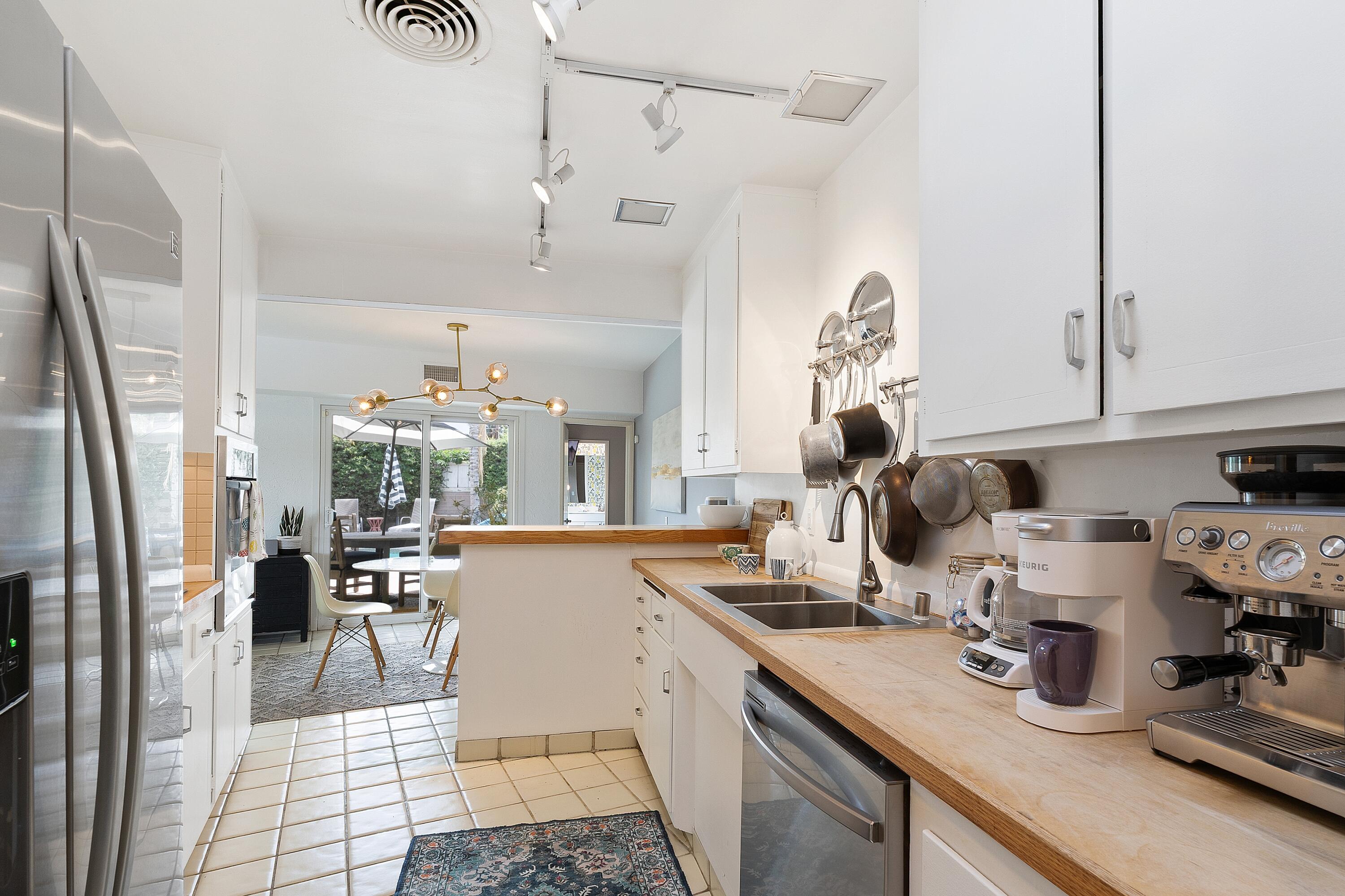 74533 Peppertree Drive Palm Desert, CA 92260 - Photo 14 of 34 a kitchen with sink and refrigerator