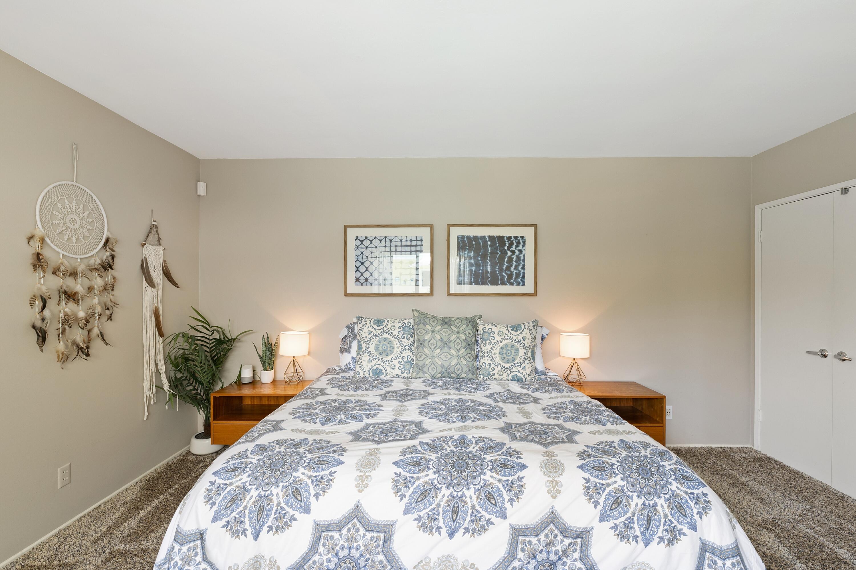 74533 Peppertree Drive Palm Desert, CA 92260 - Photo 15 of 34 a bedroom with a bed and a painting on the wall