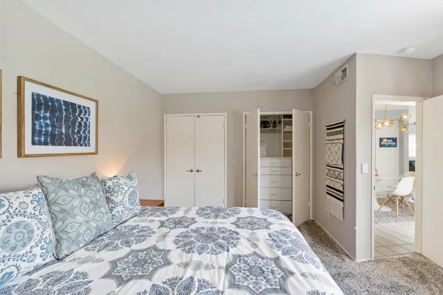 a spacious bedroom with a bed and walk in closet