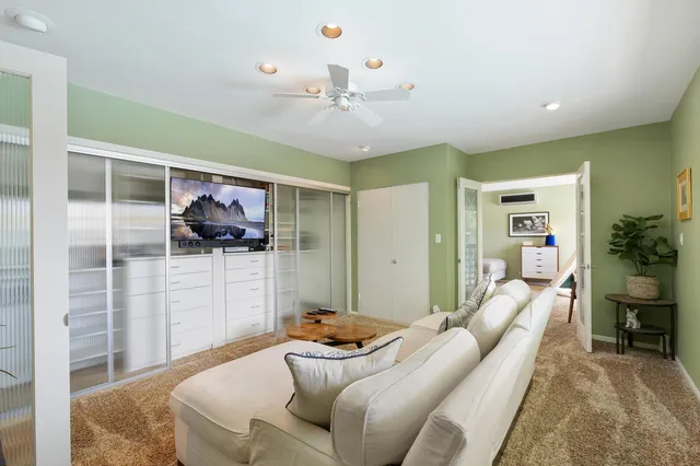 a living room with furniture and a chandelier
