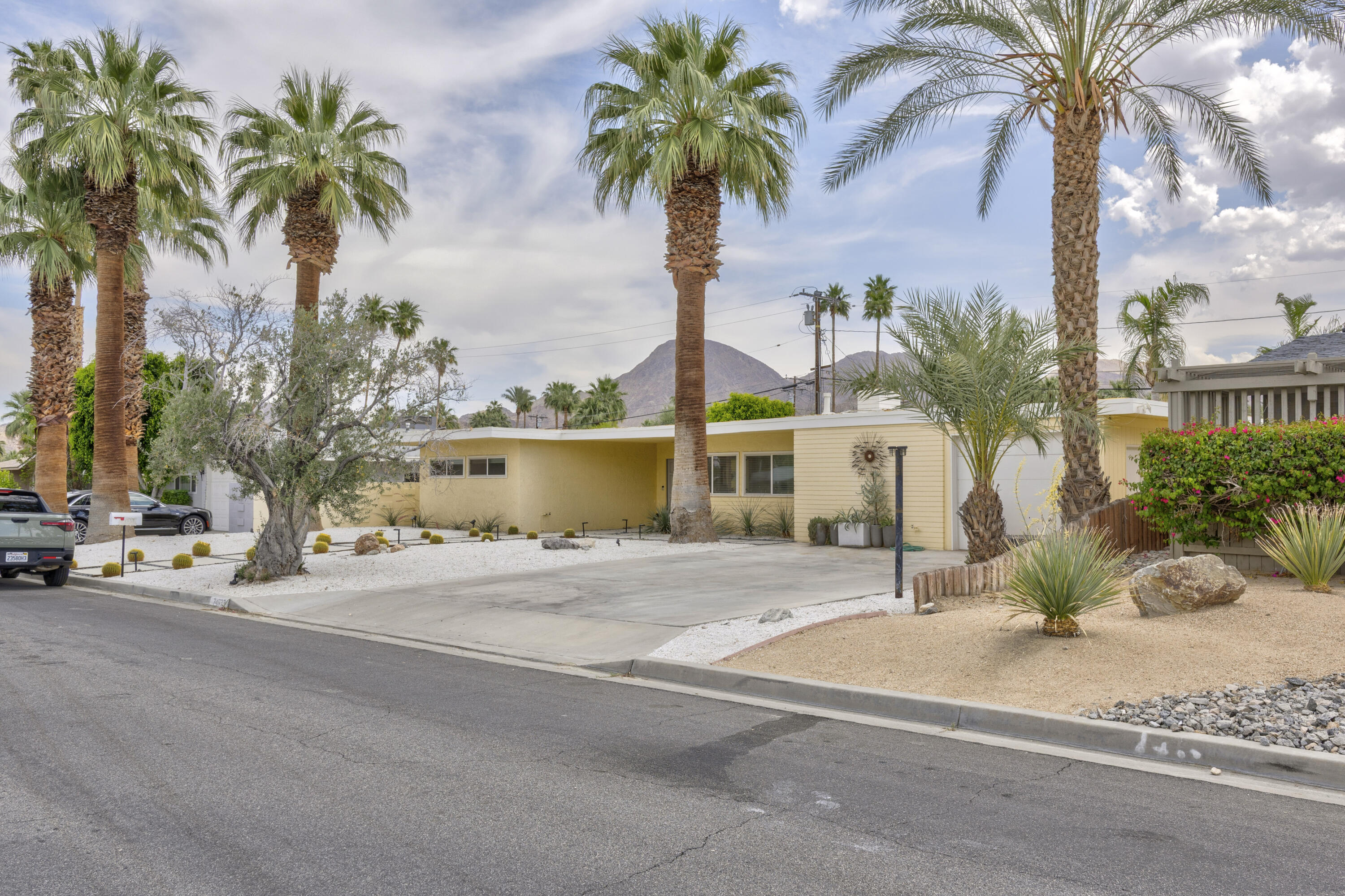 74533 Peppertree Drive Palm Desert, CA 92260 - Photo 2 of 34 a palm tree sitting in front of a house with a ocean view