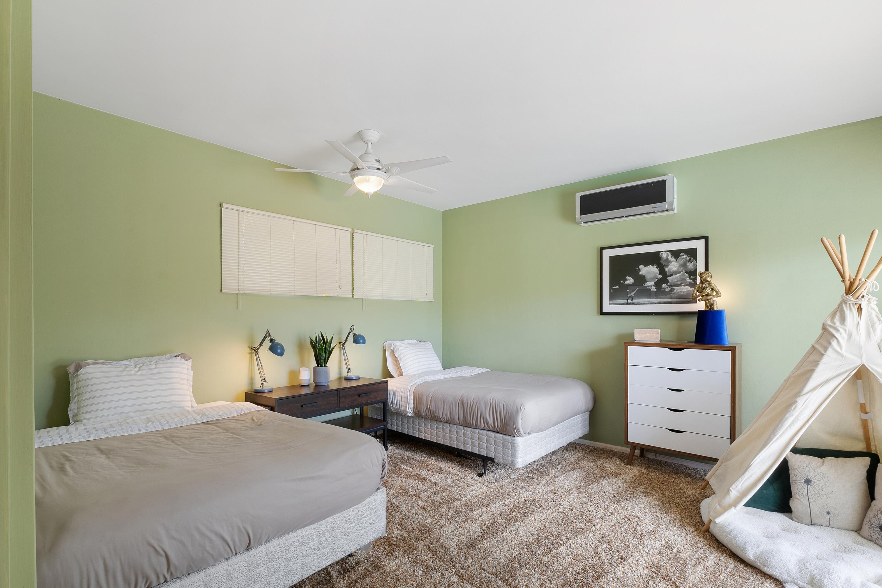 74533 Peppertree Drive Palm Desert, CA 92260 - Photo 25 of 34 a bedroom with two beds and painting on the wall