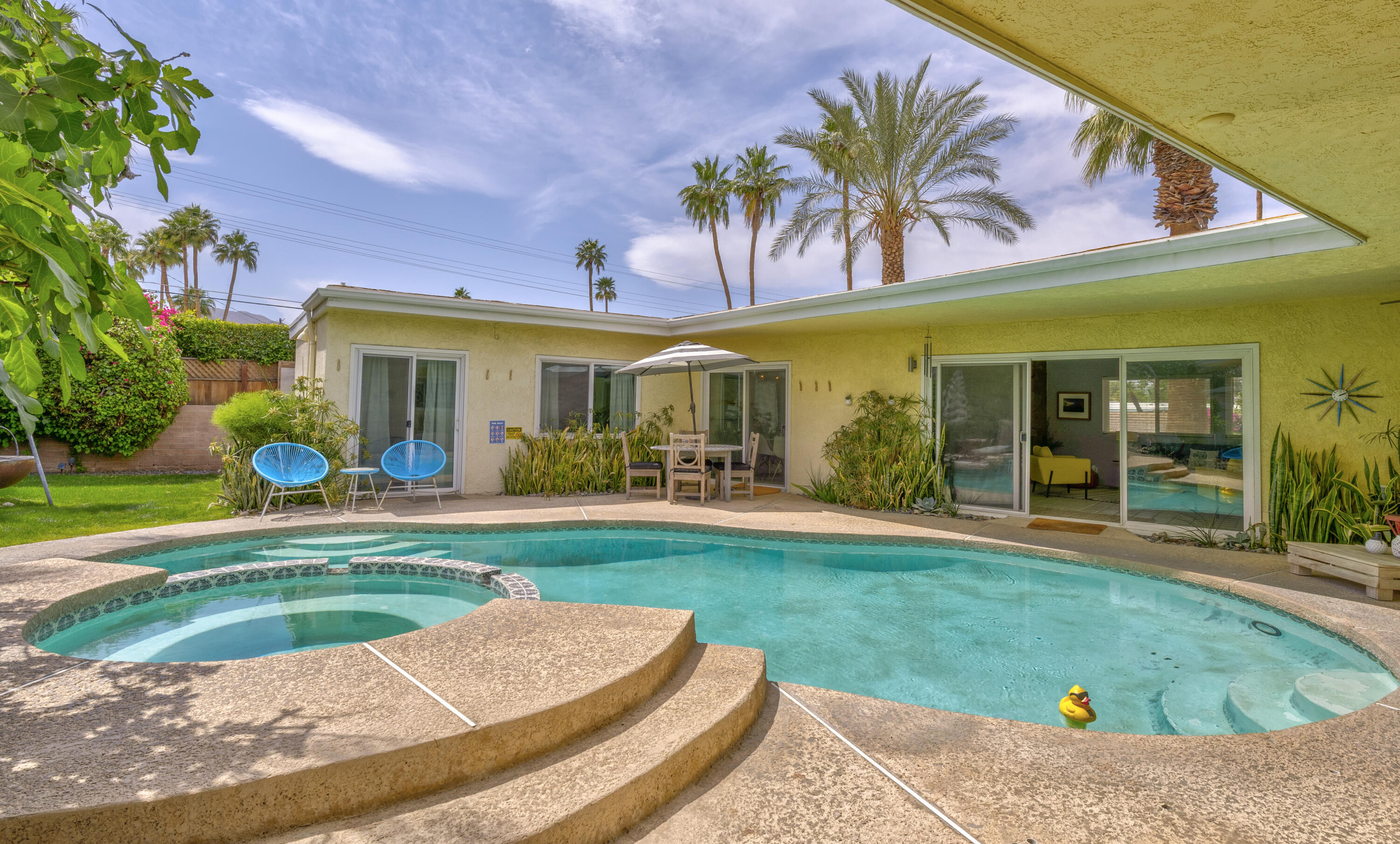 74533 Peppertree Drive Palm Desert, CA 92260 - Photo 32 of 34 a view of a house with swimming pool and a yard
