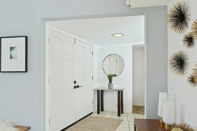 a view of a hallway with paintings on the wall