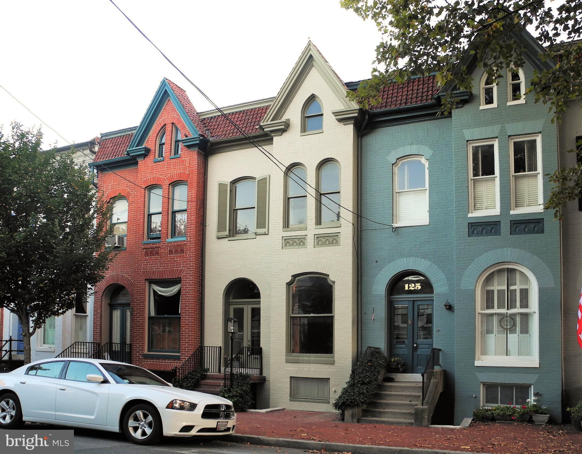 a front view of a house with parking area