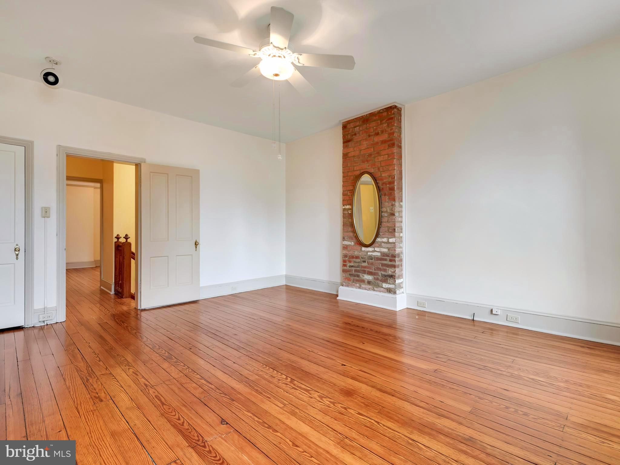 123 East 3rd Street Frederick, MD 21701 - Photo 14 of 28 a view of a livingroom with wooden floor and a ceiling fan
