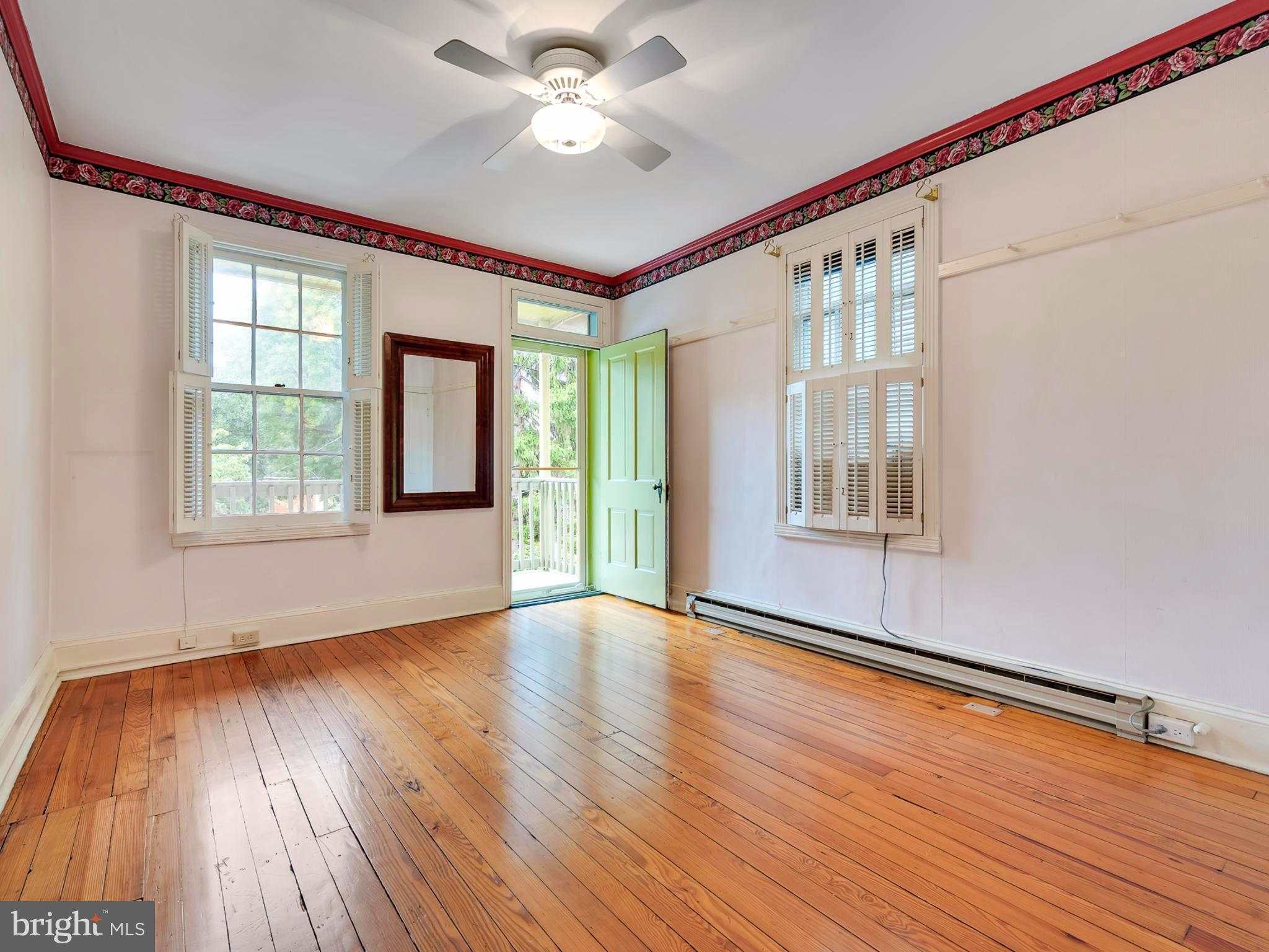 123 East 3rd Street Frederick, MD 21701 - Photo 18 of 28 a view of an empty room with wooden floor and a window